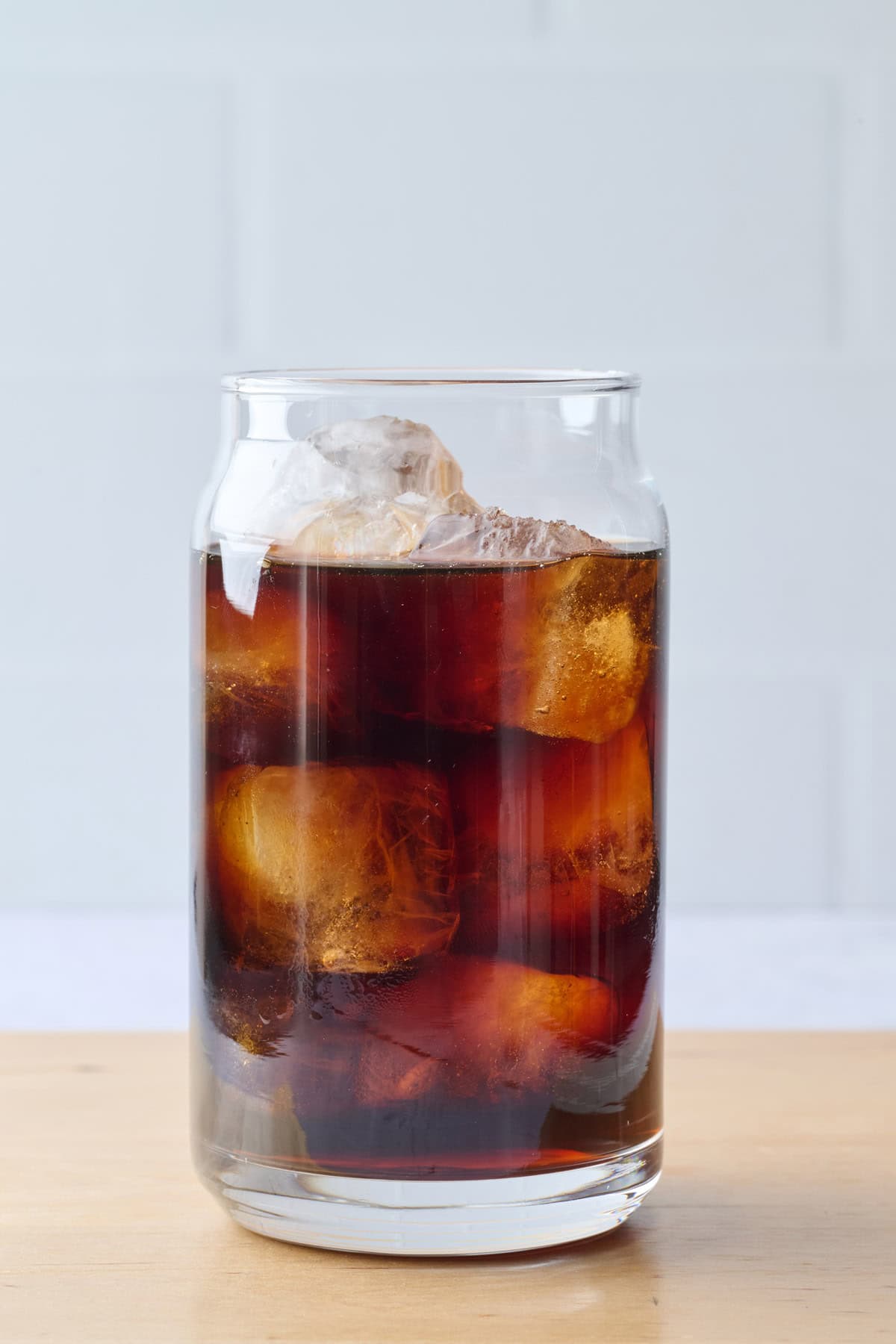 Cold brew coffee in a tall glass with ice cubes.