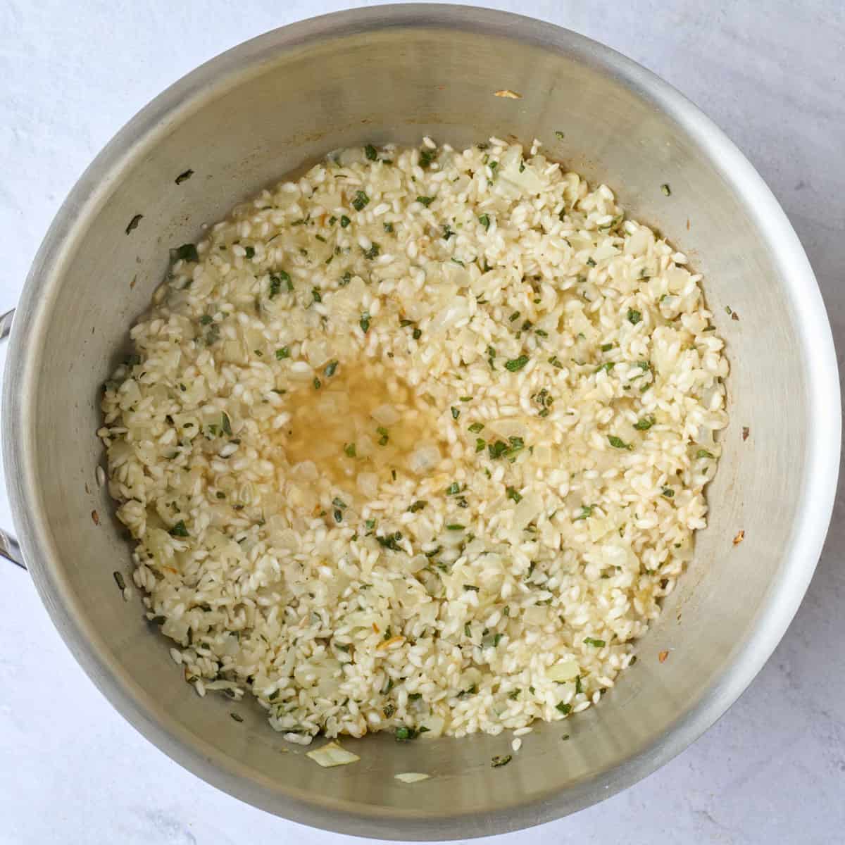 After combining the rice and onions mixture together in a pot with some broth added on top.