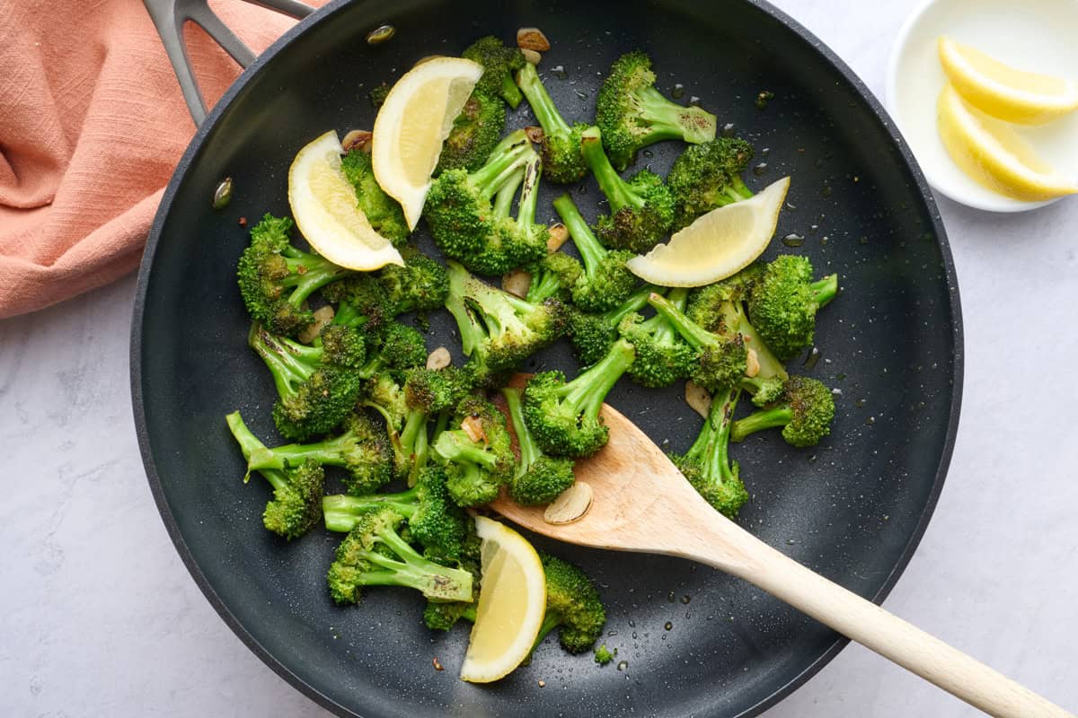 Pan sauteed broccoli with garlic in a pan after cooking.