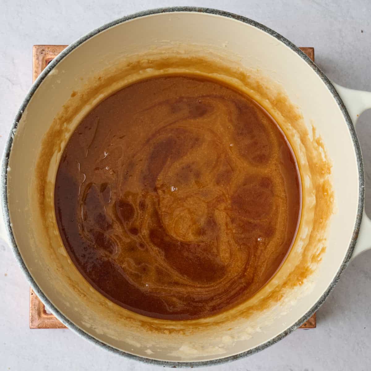 Homemade caramel mixture for brittle recipe in a pot.