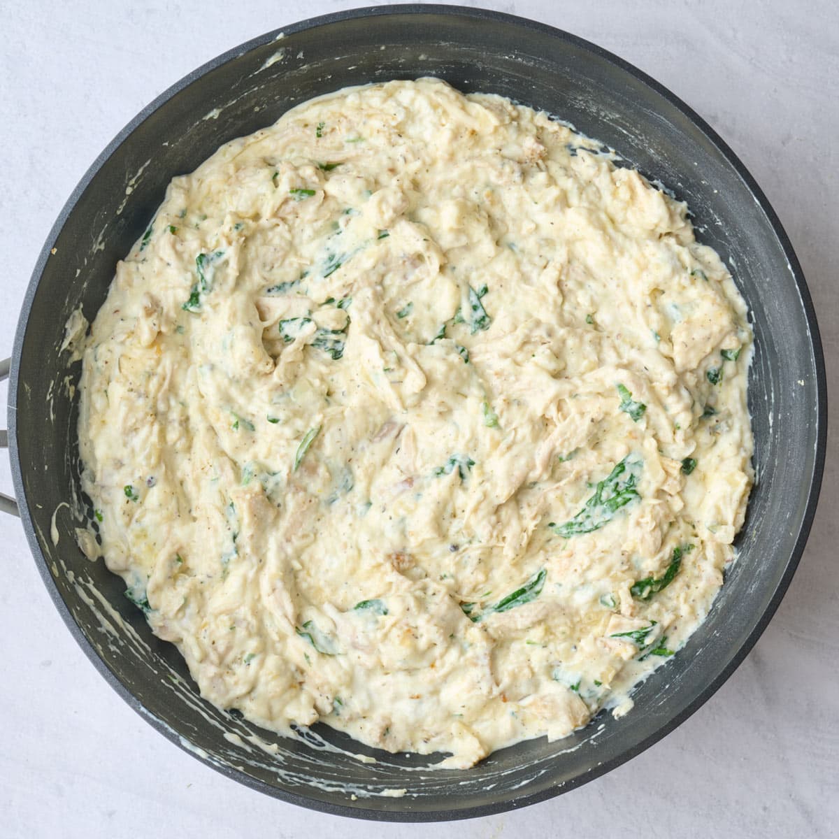 Chicken lasagna filling after combining in pan.