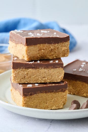 Easy no bake chocolate peanut butter dessert bars stacked on top of eachother.