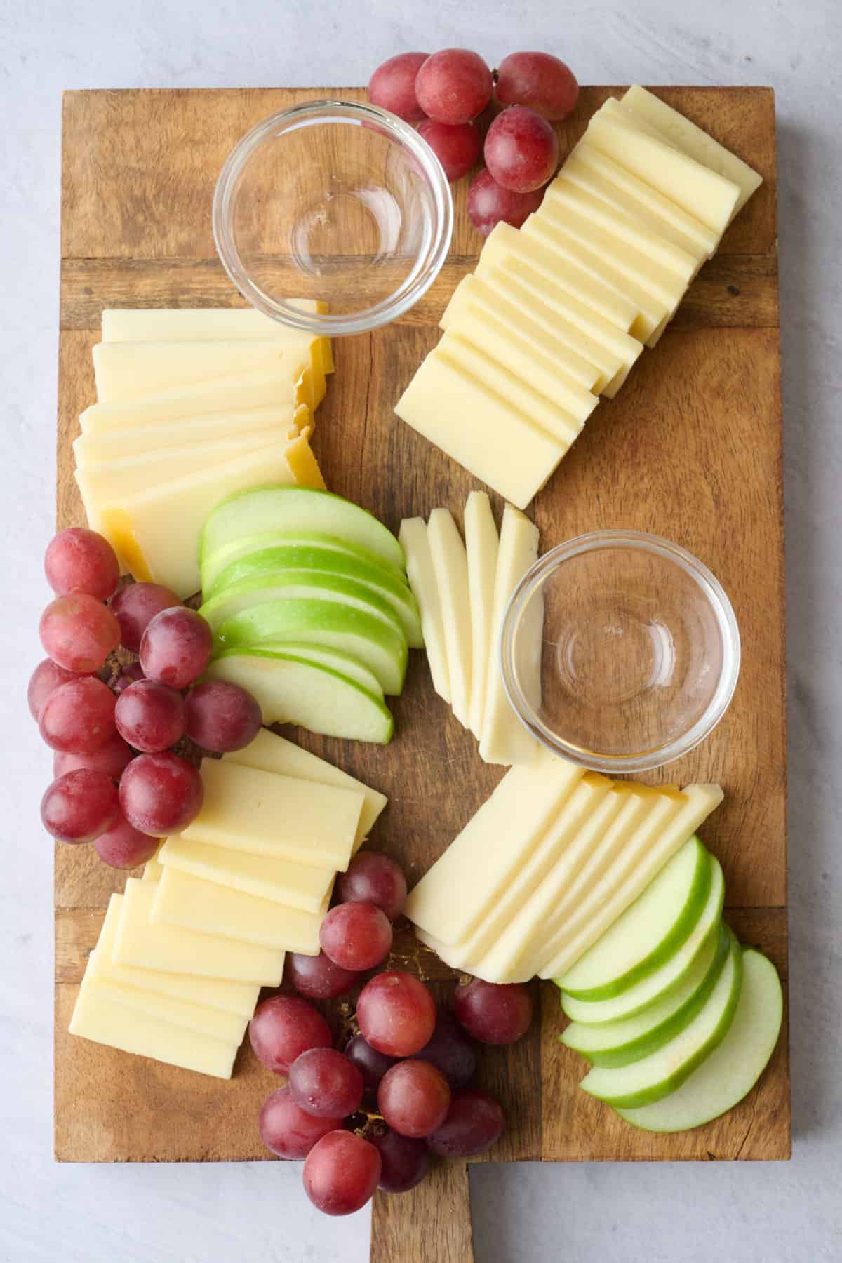 Grapes and sliced apples added to cheese board.