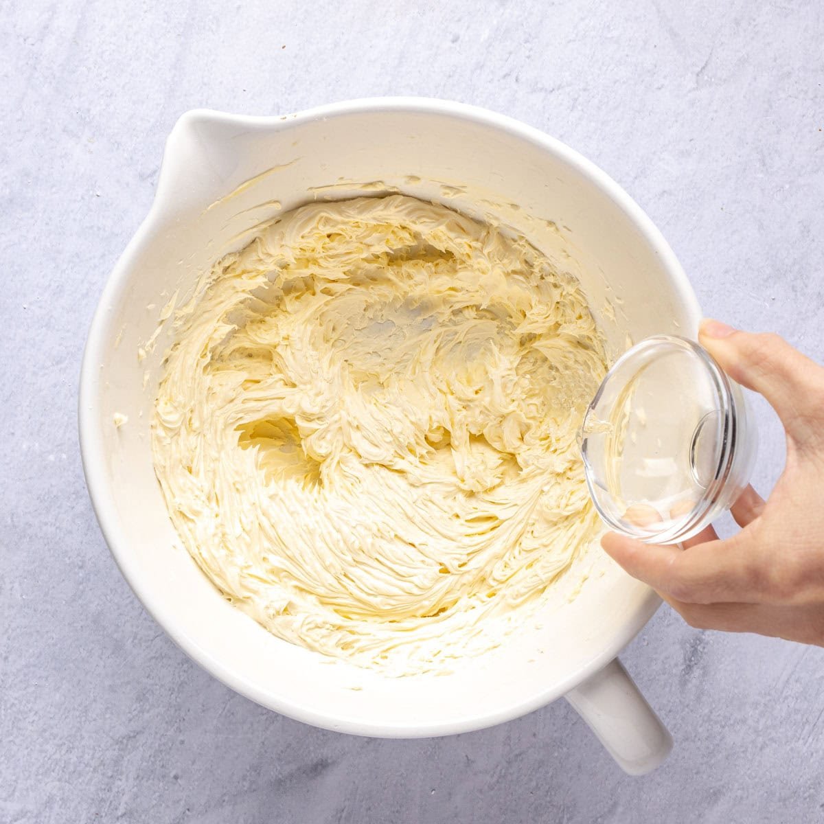 Rose water being added to shortbread cookie recipe before flour is added.