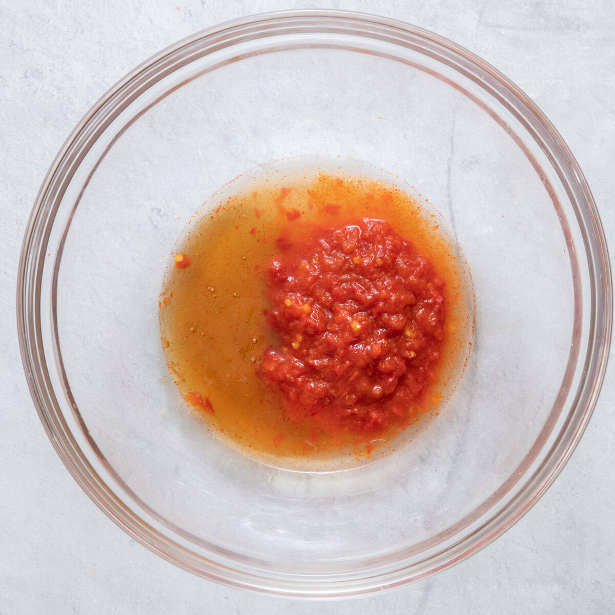 Harissa, honey, lemon juice and oil in a small bowl before mixing.