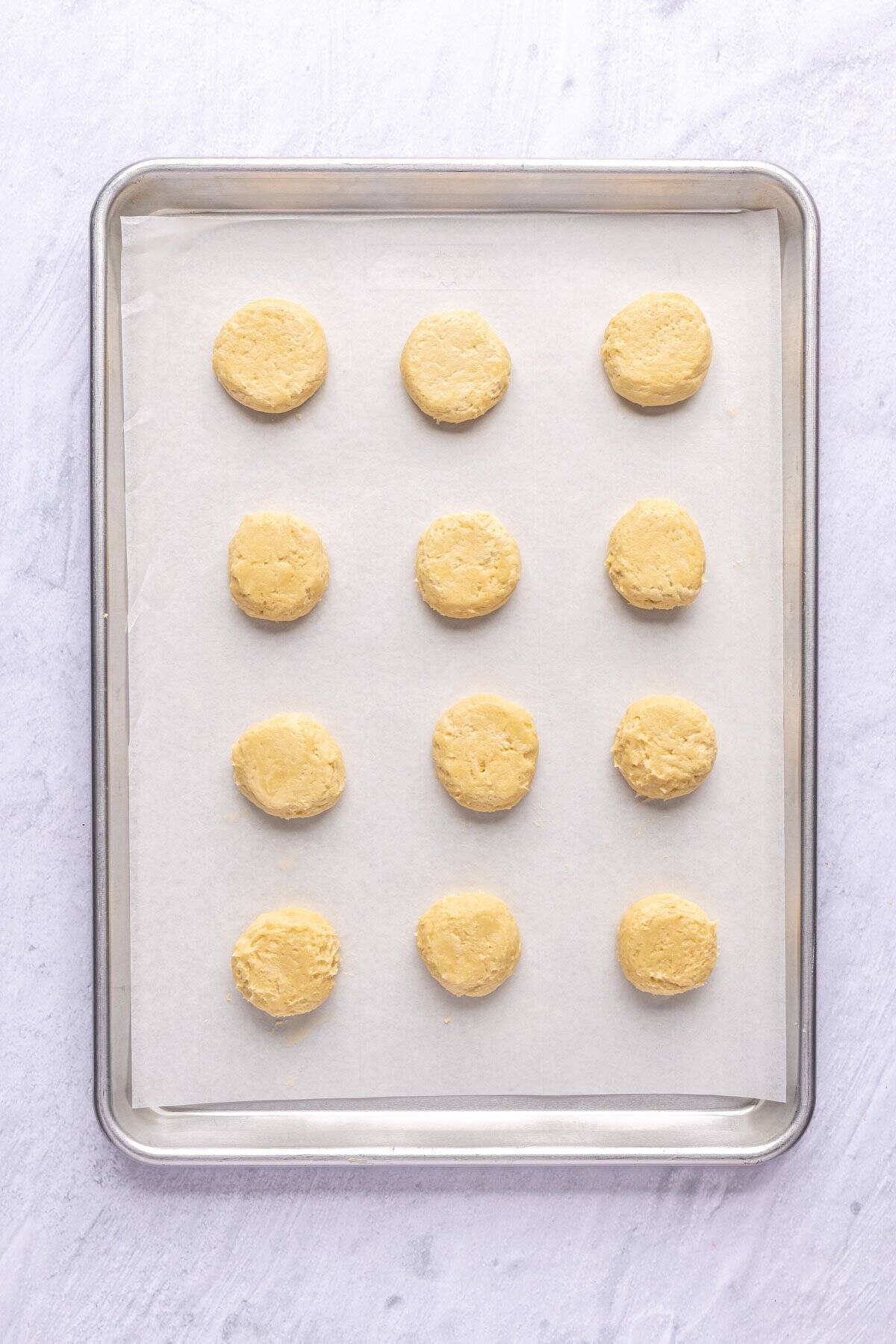 After slightly flattening cookie dough ball tops on sheet pan.