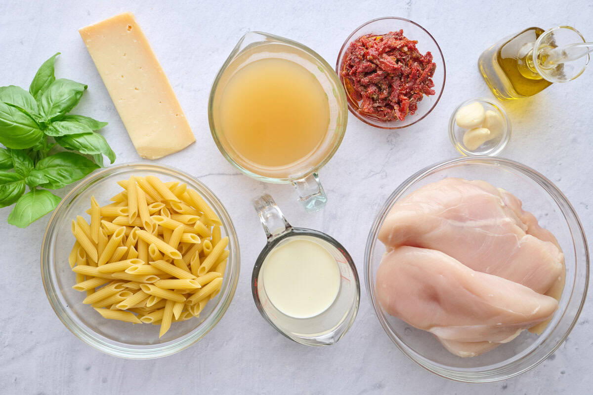 Ingredients for marry me pasta recipe: penne pasta, chicken breast, parmesan, sun-dried tomatoes, broth, creamy, garlic cloves, oil, and fresh basil.