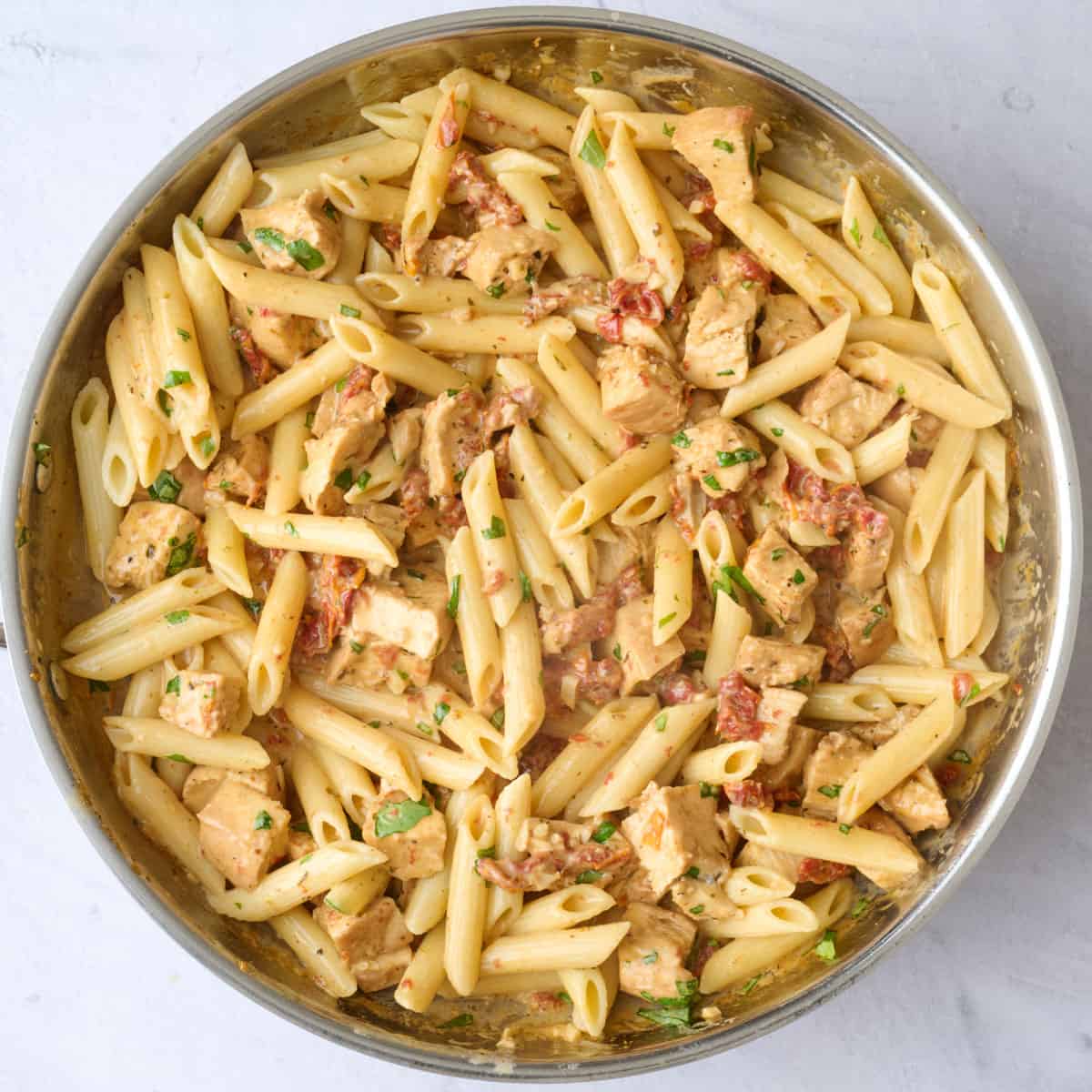 Marry me pasta recipe with chicken after tossing together in a pan.
