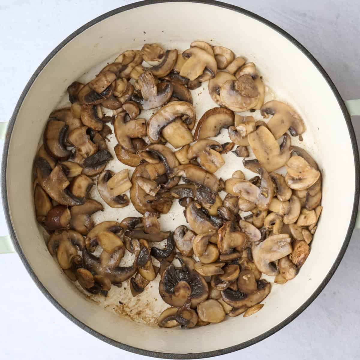 Sliced mushrooms after browning in a pot for soup recipe.