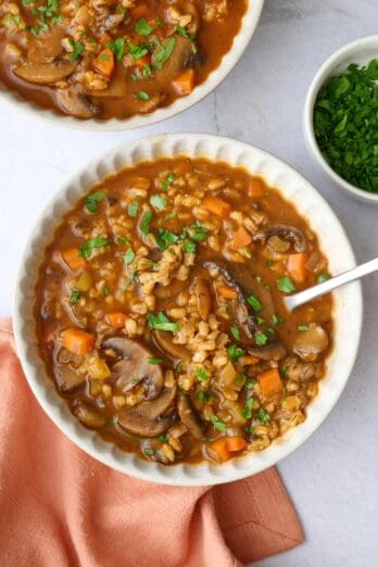 Two bowls of vegetarian mushroom barley soup.