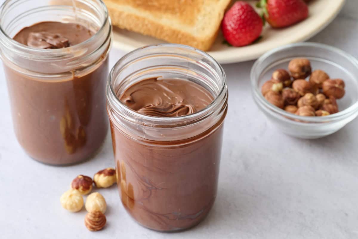 Homemade Nutella hazelnut chocolate spread recipe in glass jars.