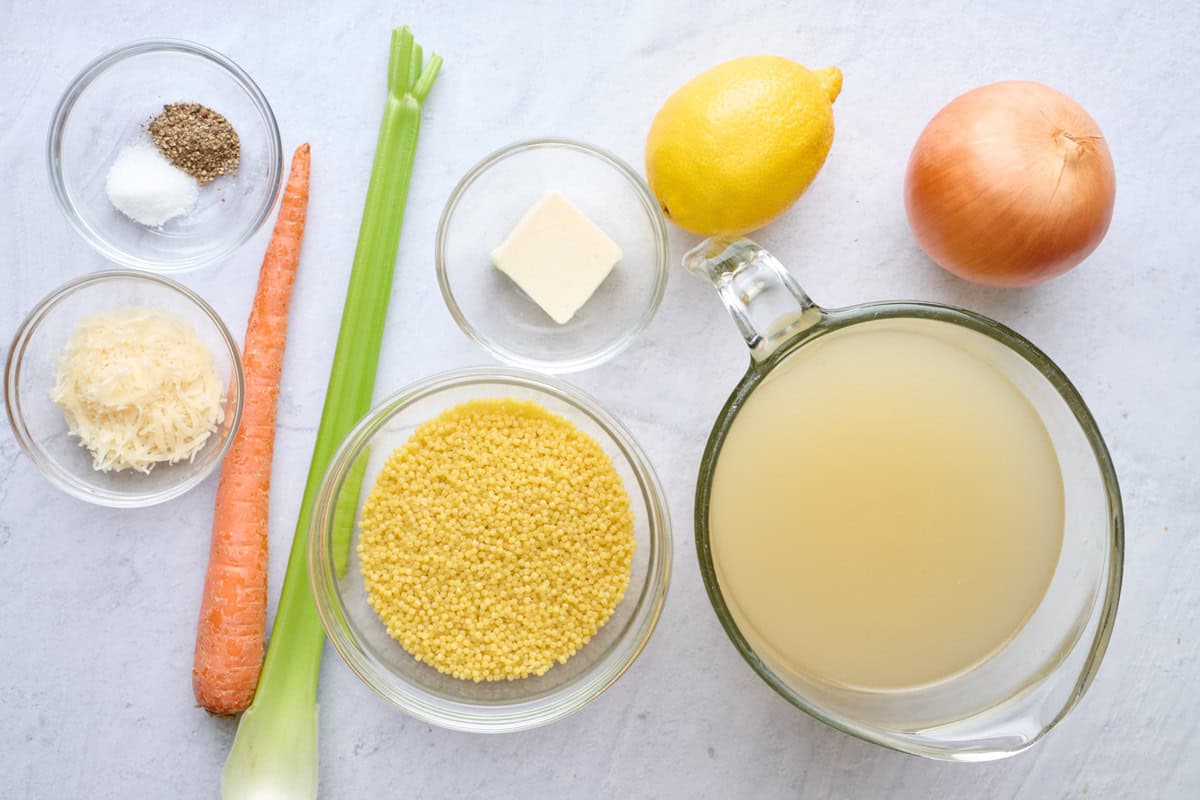 Ingredients for soup recipe: salt, pepper, parmesan, carrot, celery, pastina, butter, lemon, broth, and onion.