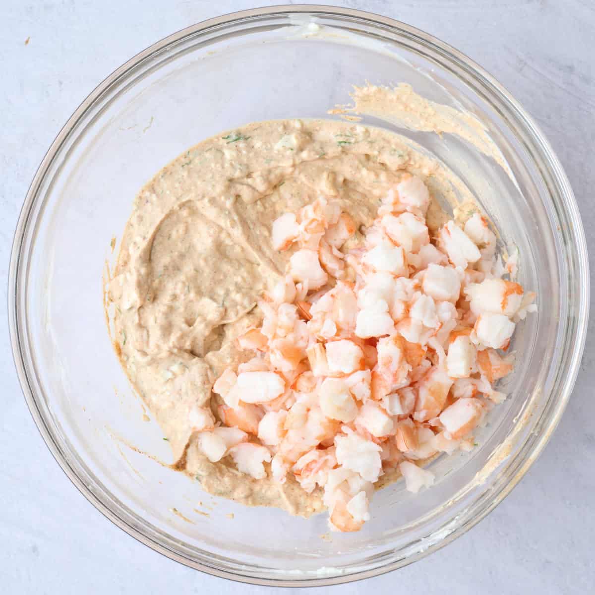 Creamy dip mixture with chopped cooked shrimp added on top before combining.