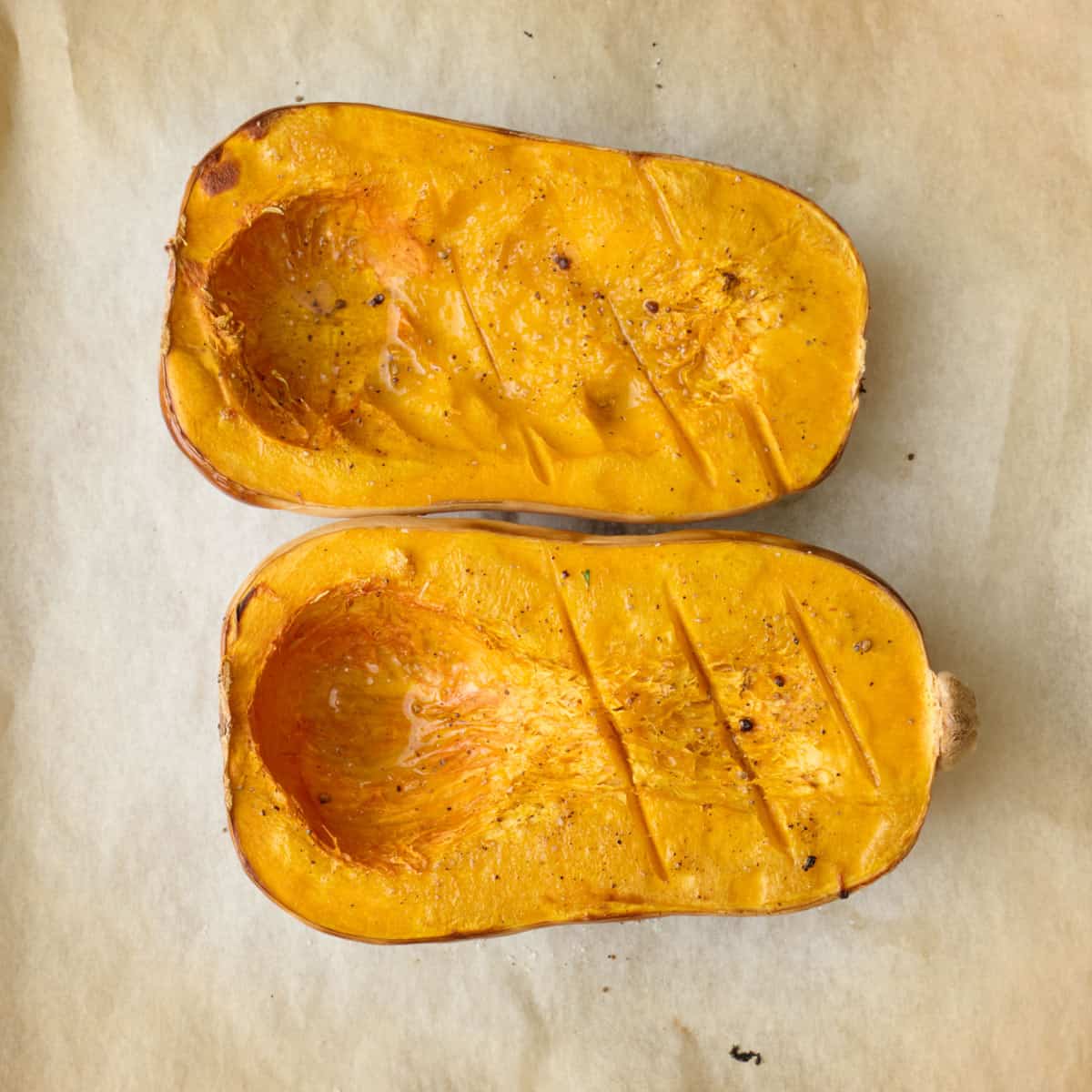 Roasted butternut squash on parchment paper.