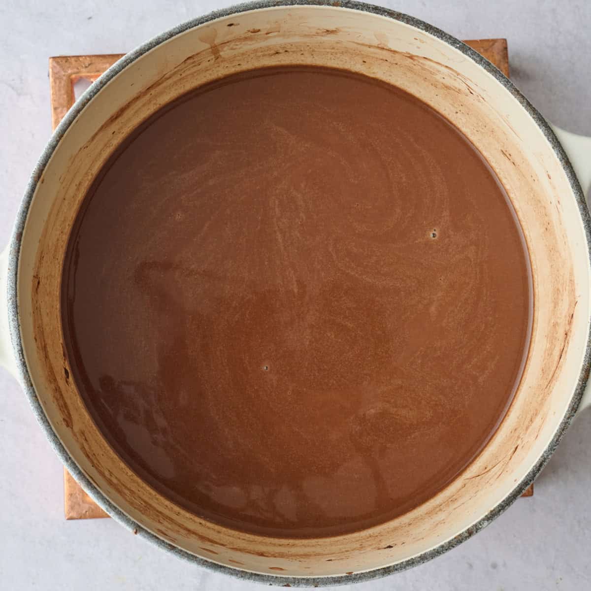 Homemade almond milk hot chocolate in the pot after combining.