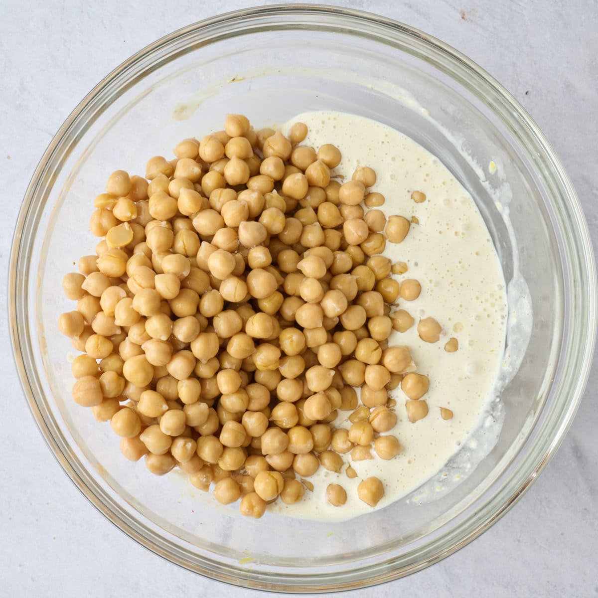 Salad dressing after mixing with chickpeas added on top.