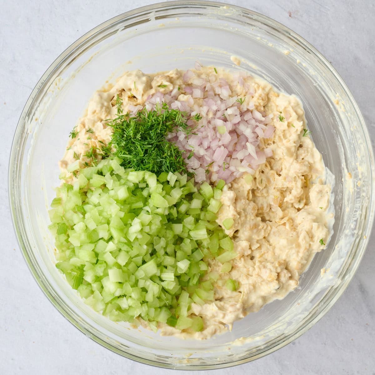 Chickpeas and dressing after mashing with celery, shallots and dill added before combining.