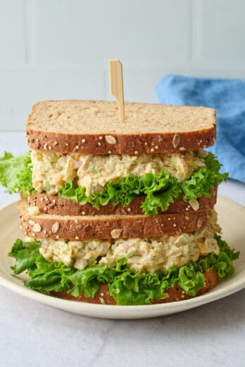 Two chickpea salad sandwiches stacked on top of each other.