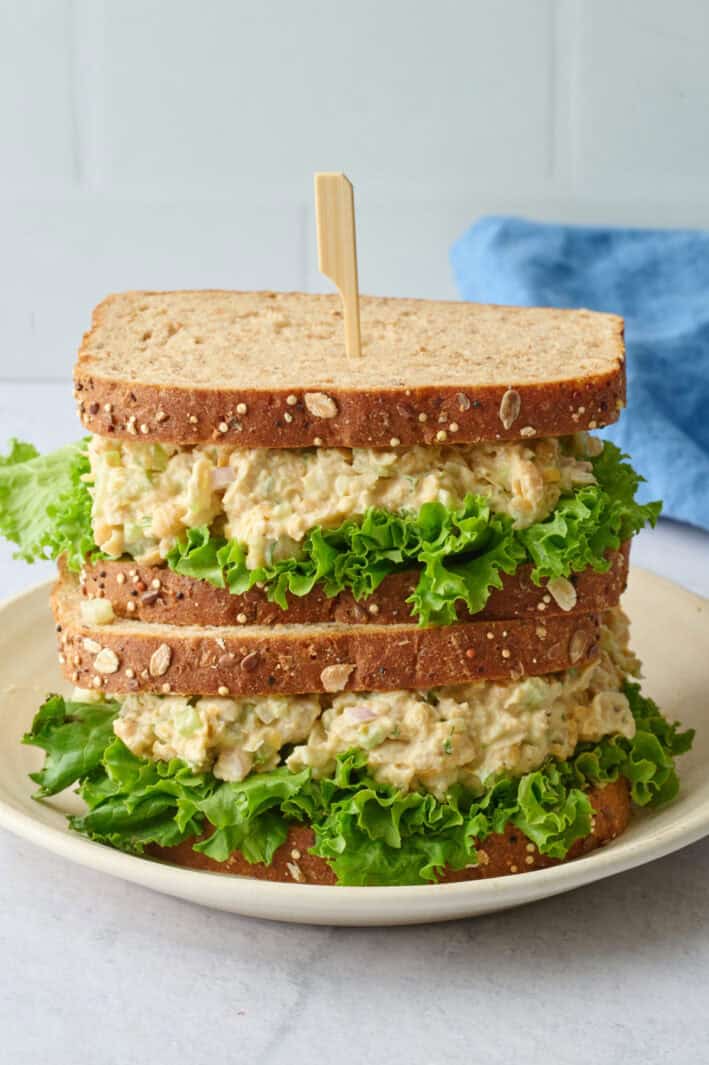 Two chickpea salad sandwiches stacked on top of each other.