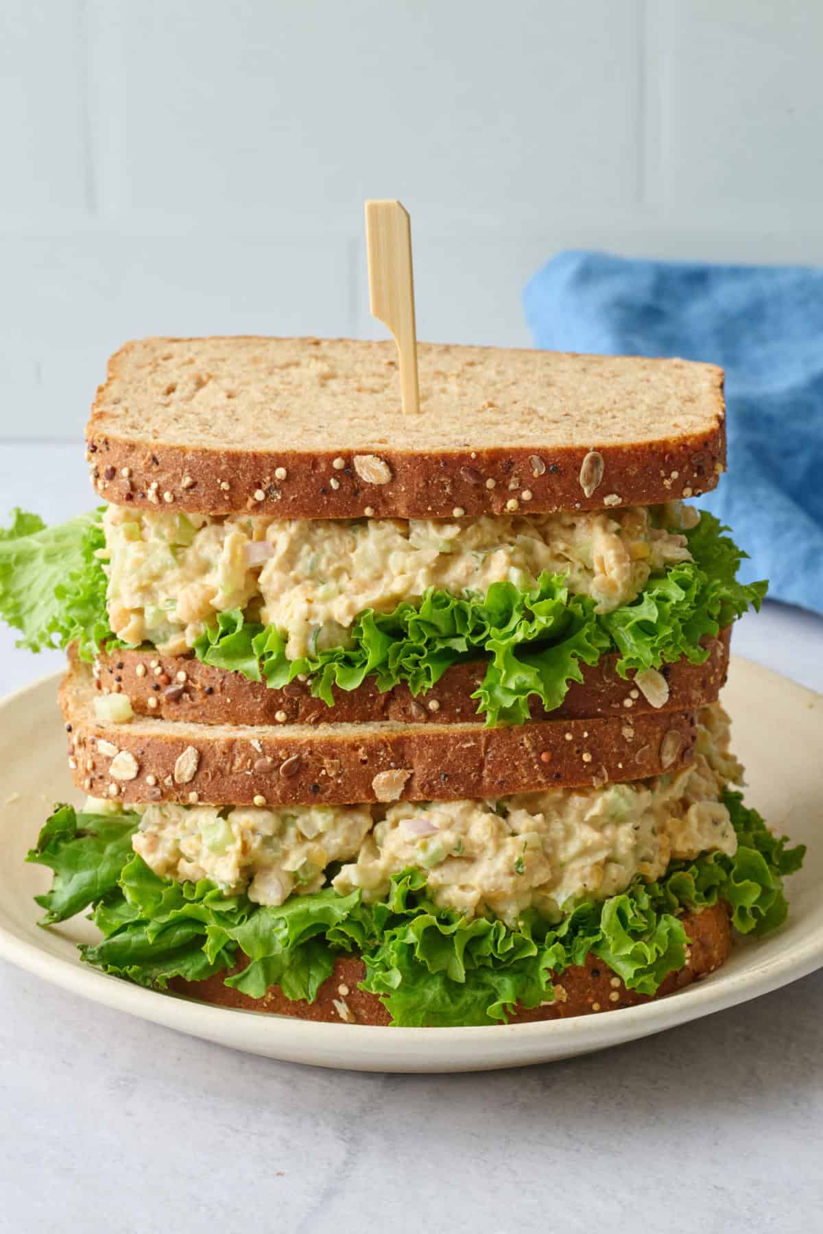 Two chickpea salad sandwiches stacked on top of each other.