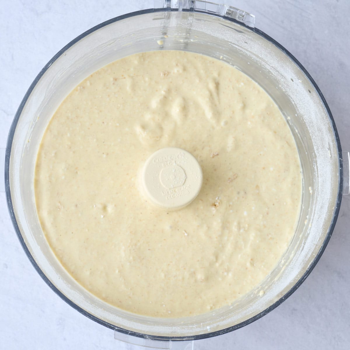 Waffle batter of blending together in a food processor.
