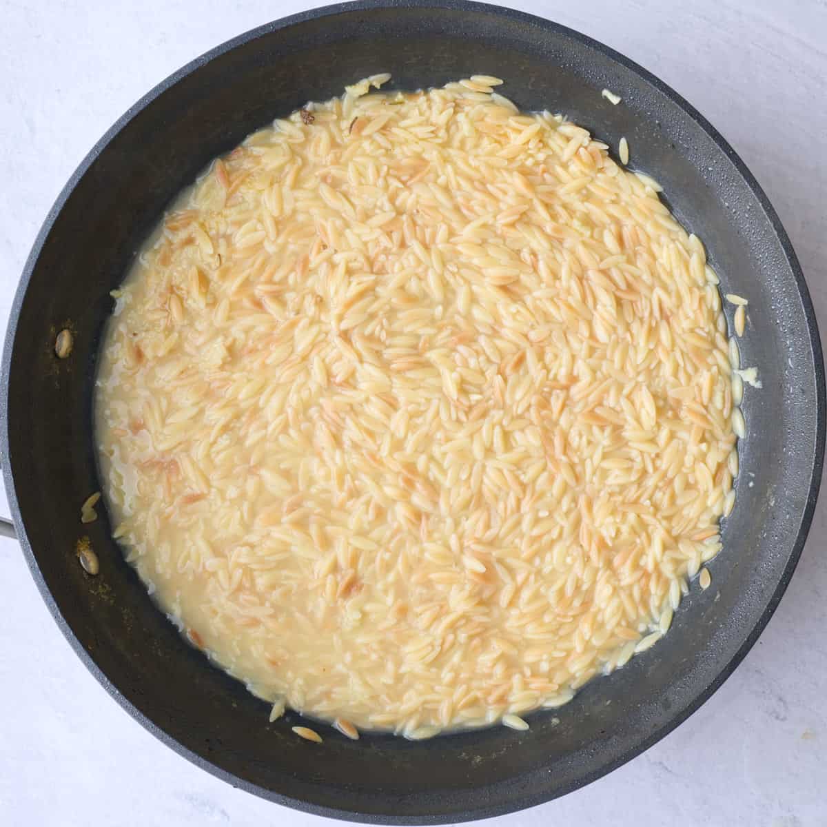 After orzo is tender and has absorbed most of the chicken broth.