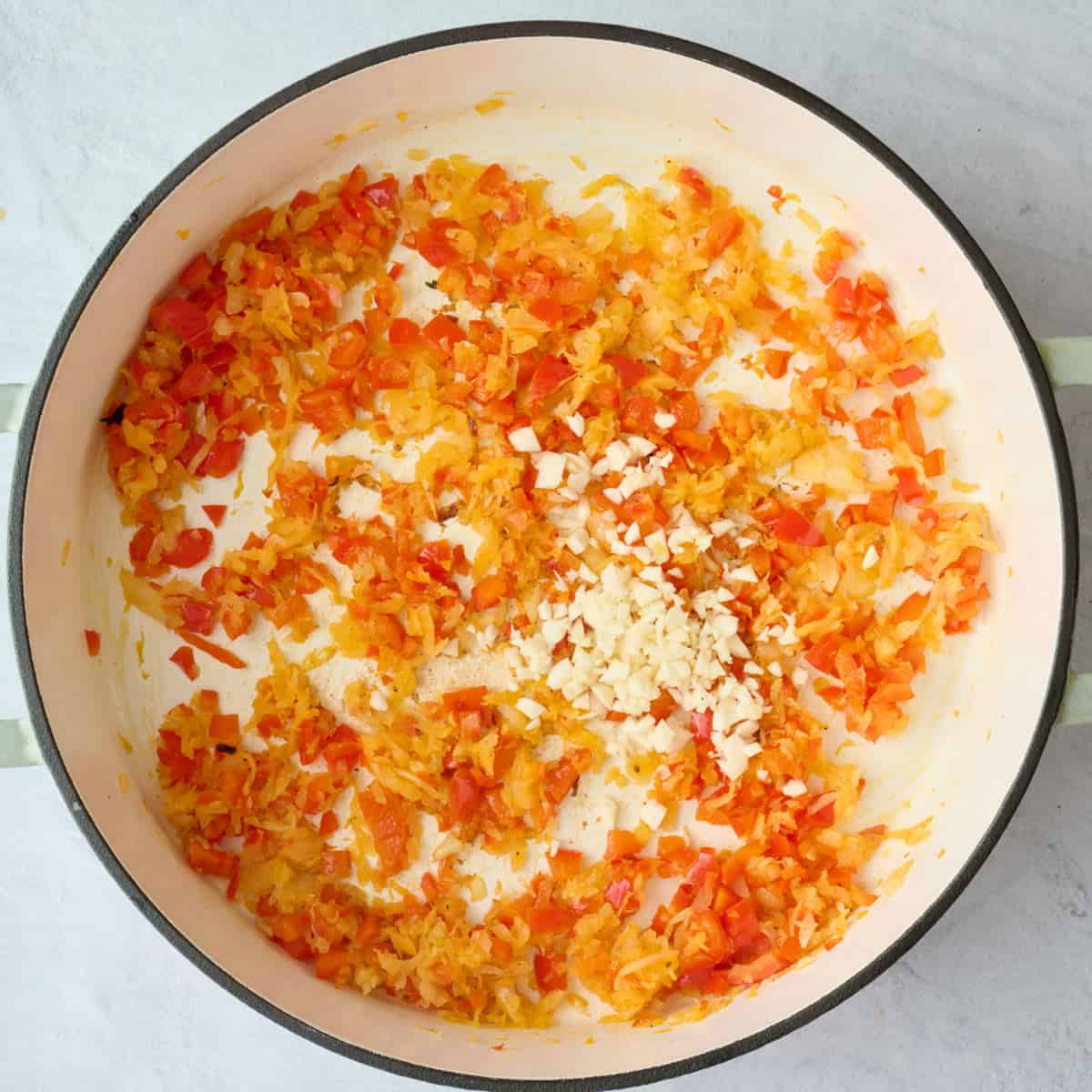 Peppers and onions after cooking with minced garlic added on top.