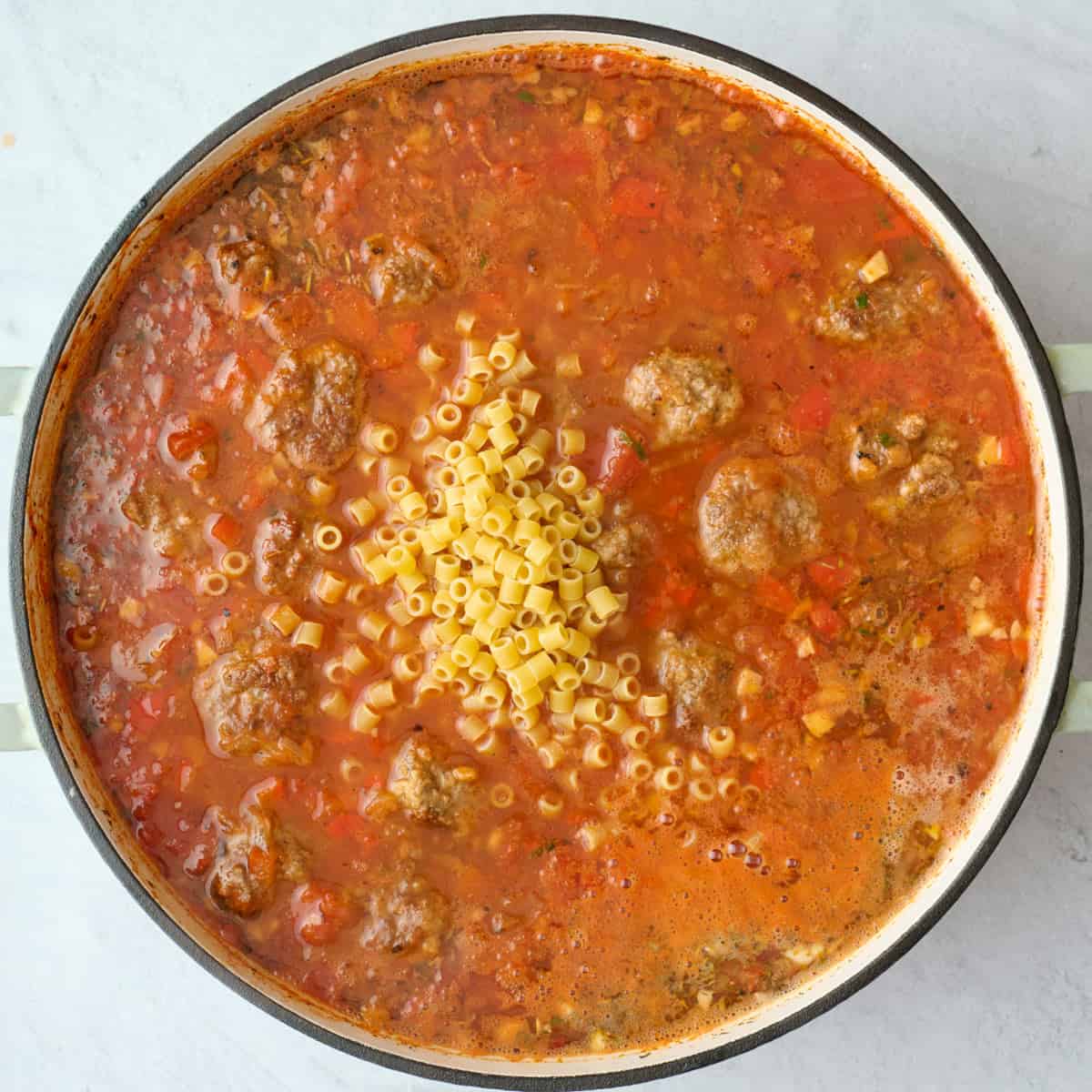 Meatball soup after simmering with ditalini pasta added before combining.