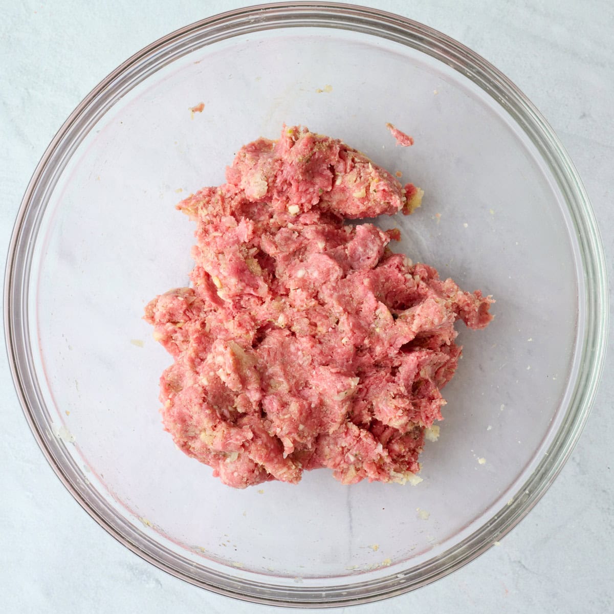 Meatball mixture after combining in a bowl.
