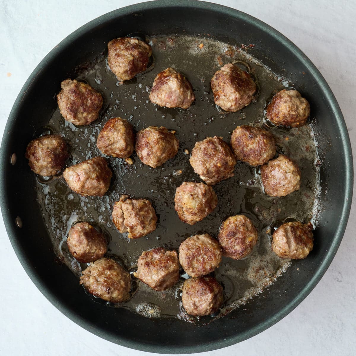 After meatballs have cooked through in skillet.