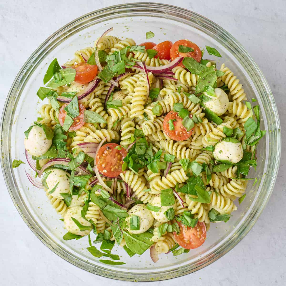Fresh basil on top of tossed pasta salad.