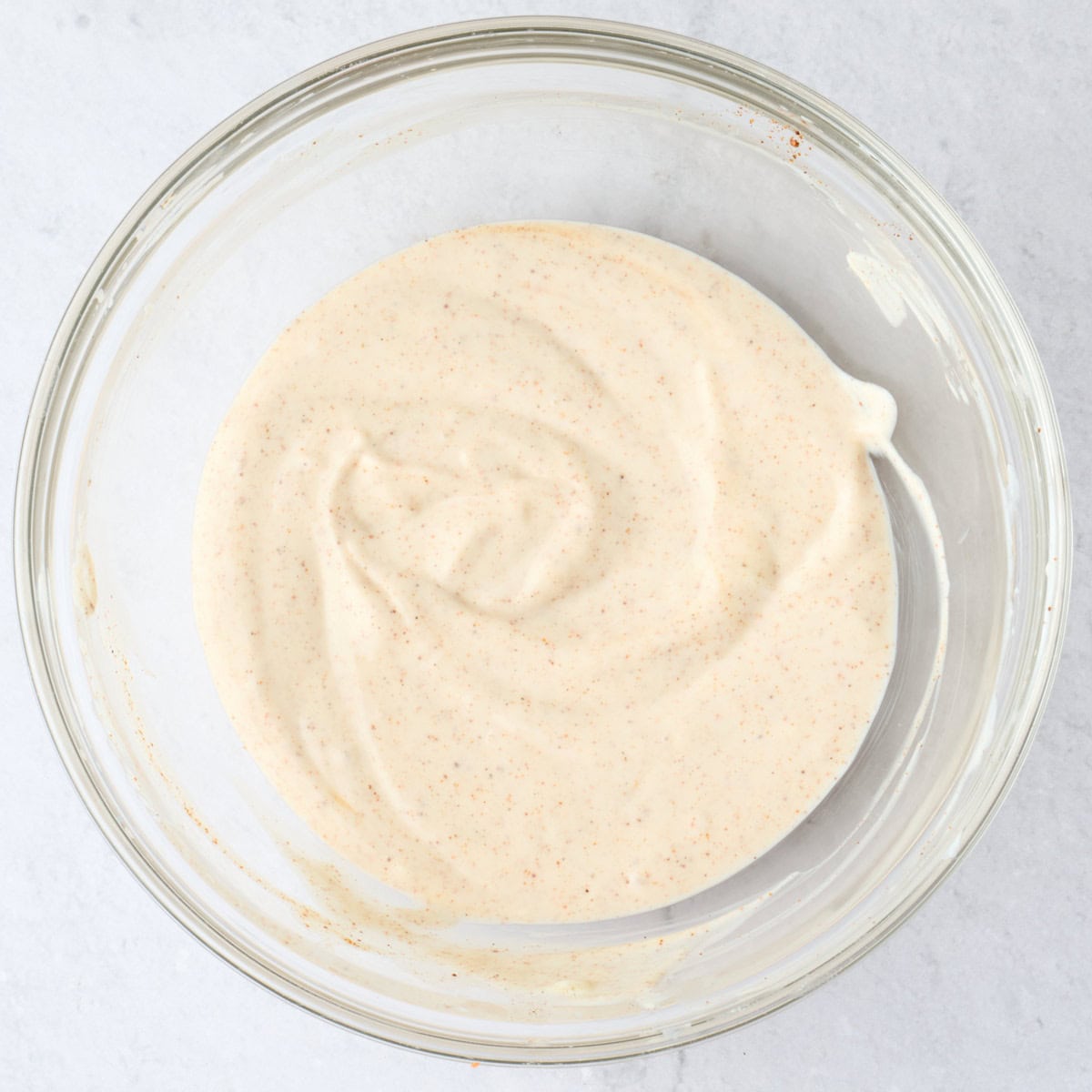 Creamy taco yogurt sauce after mixing in bowl.