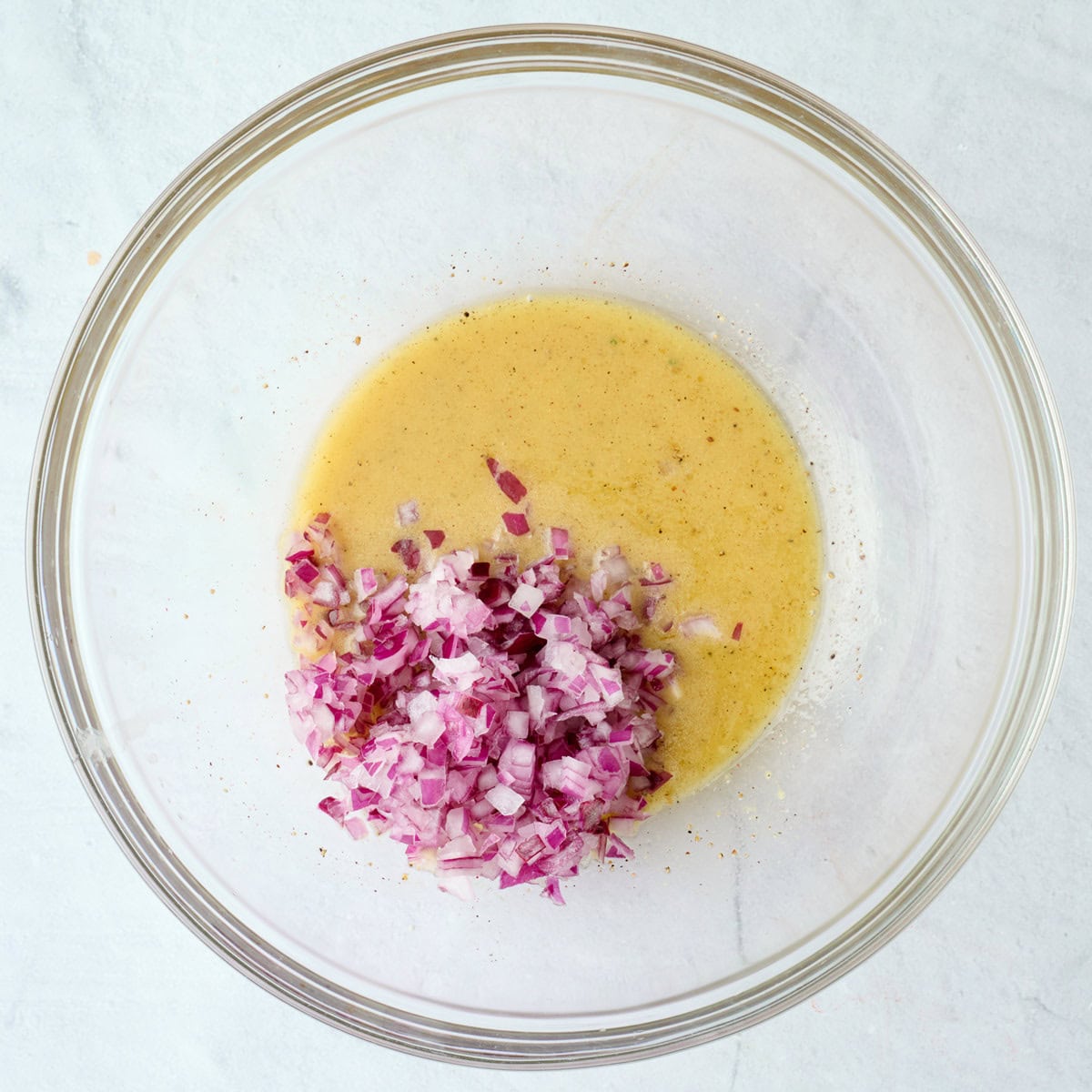 After zesty dressing is emulsified with finely diced red onions added.