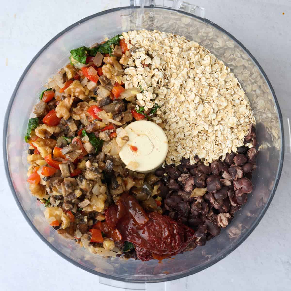 Beans, veggie mixture, oats and chipotle in a food processor before processing into burger meat.