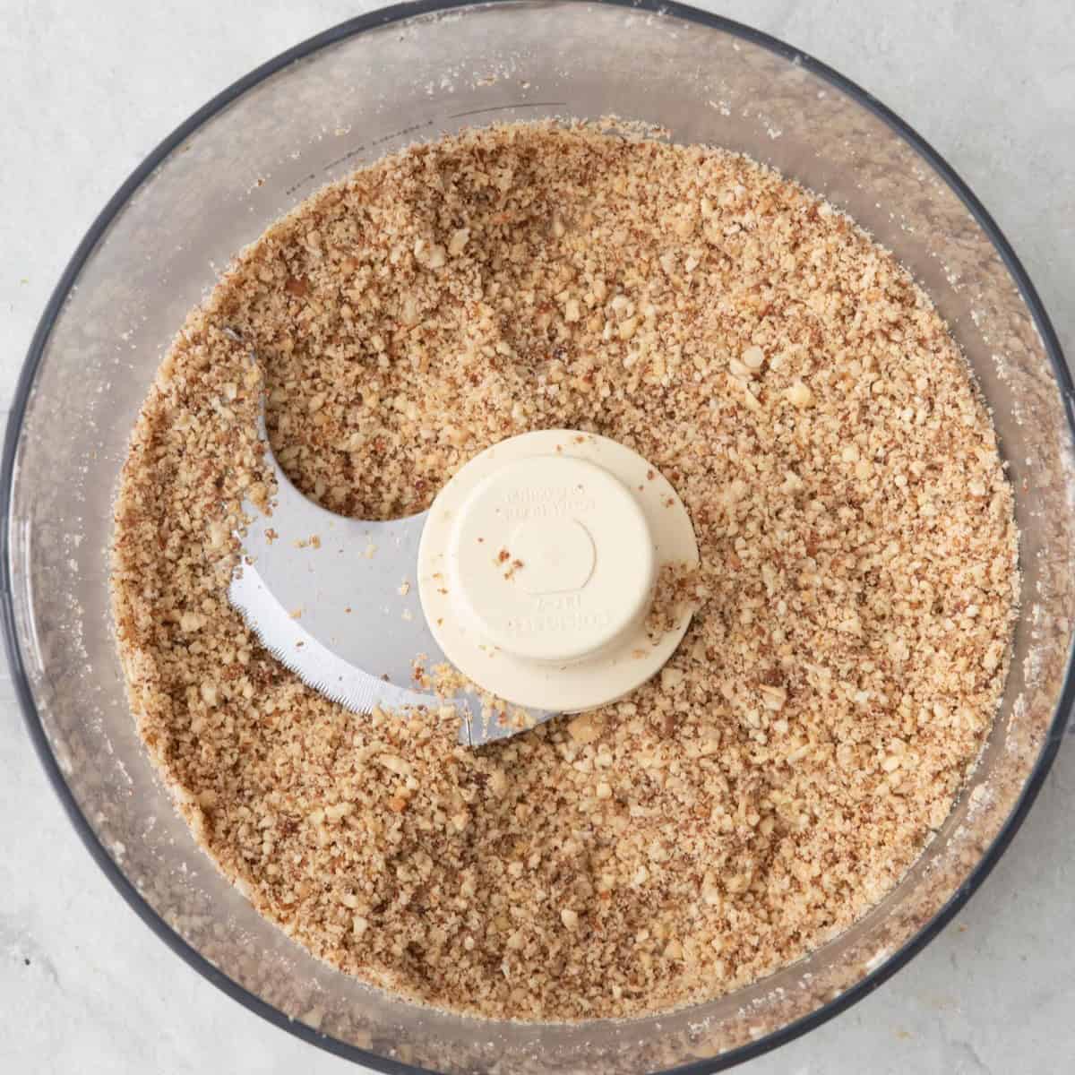 Almonds after processing into crumbs in a food processor for coating chicken.