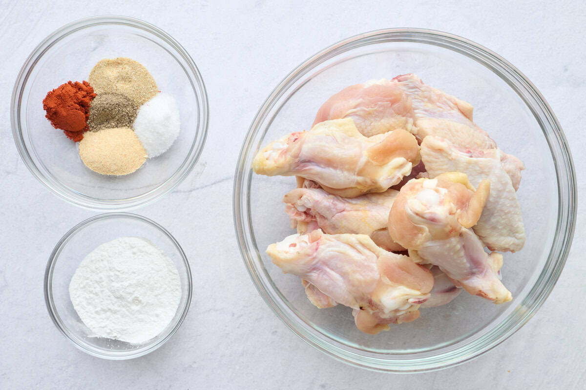 Ingredients for baked wings recipe: chicken wings and drumettes, seasoning blend, and cornstarch.