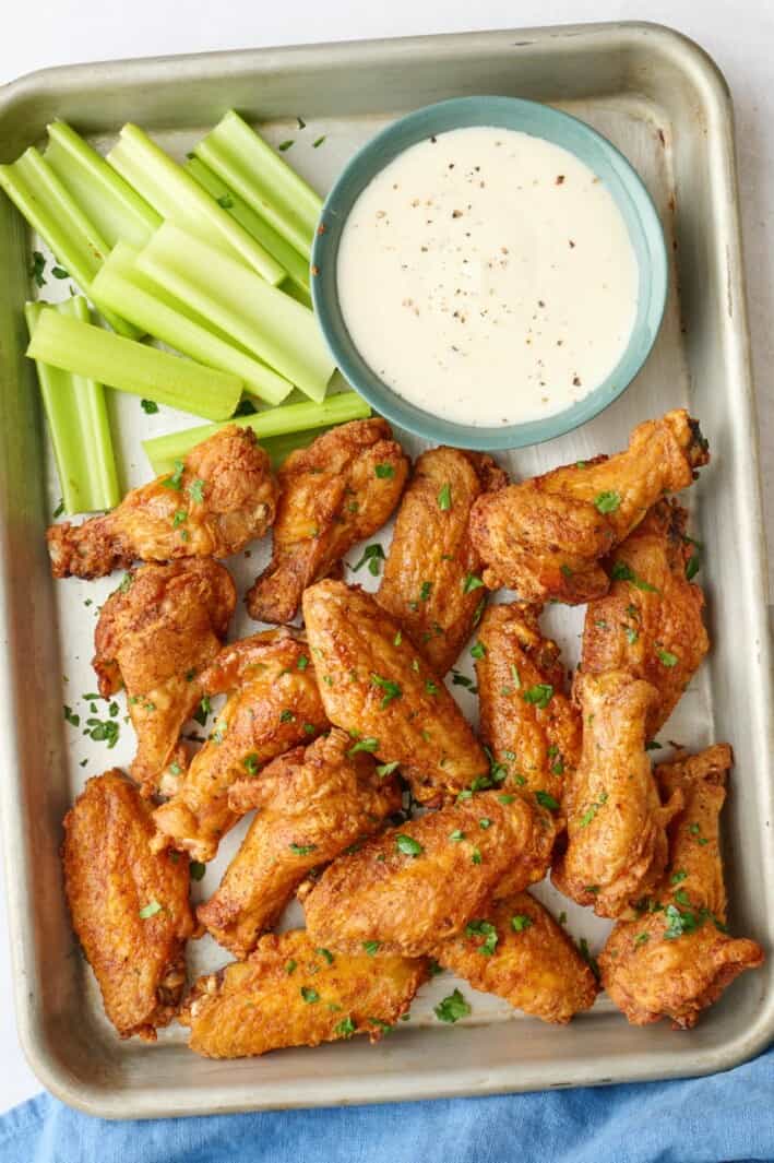 Best baked chicken wings served with celery sticks and ranch.