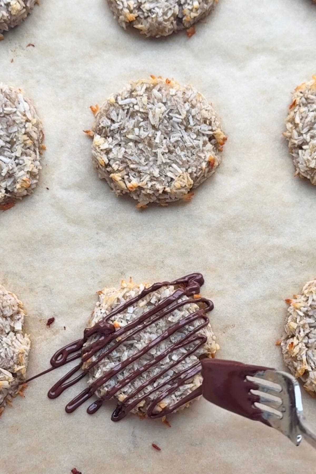 Drizzle chocolate on coconut 1 ingredient banana coconut cookies.