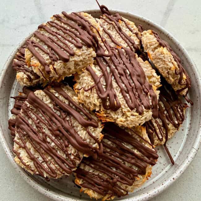 Viral 2 ingredient banana coconut cookies topped with a chocolate drizzle.