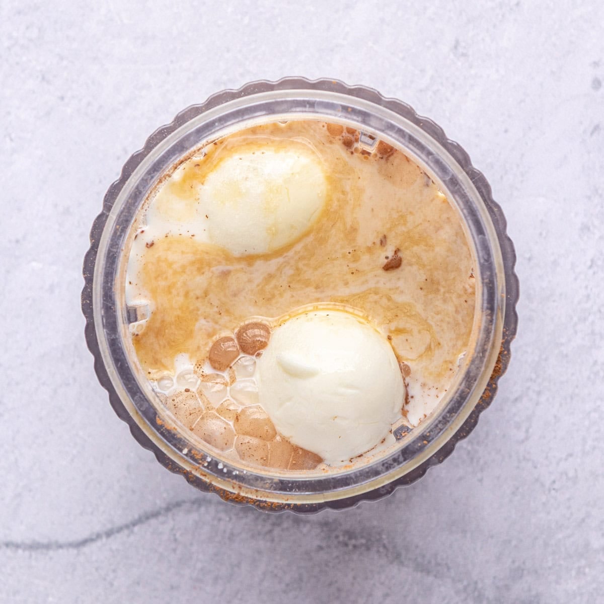 Hard boiled eggs and other pudding ingredients in a small blender before blending.