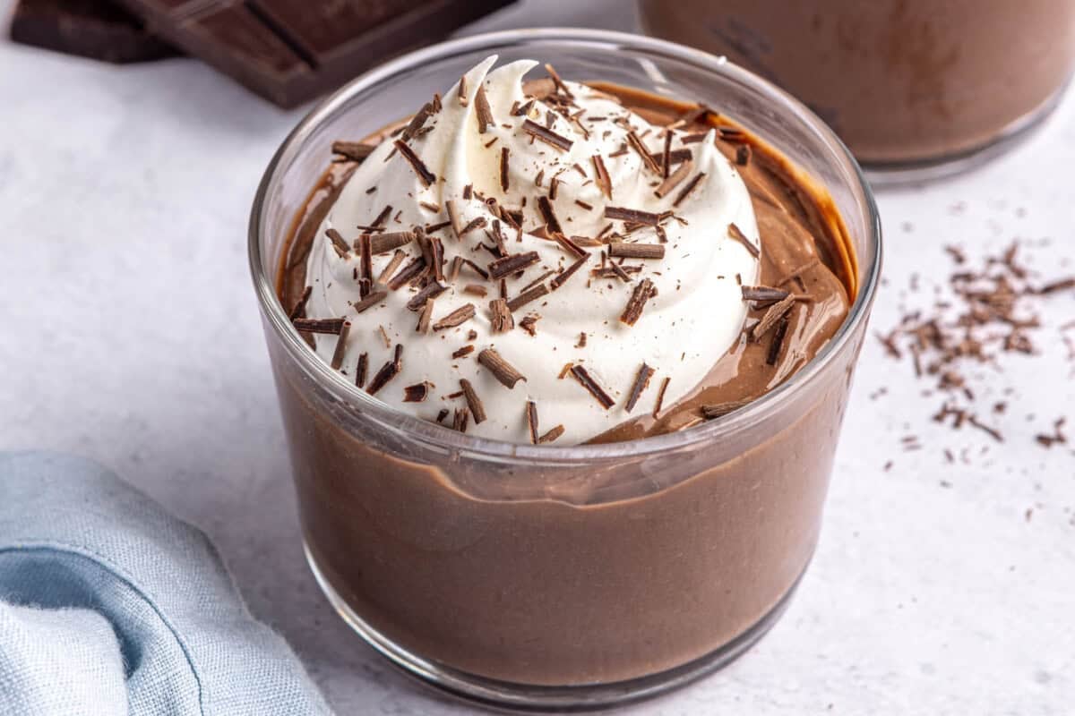 Hard boiled egg chocolate pudding dessert in a glass topped with whipped creamy and chocolate.