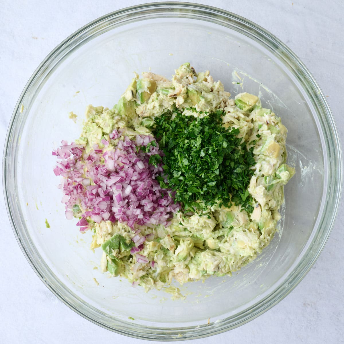 After tossing together chicken and avocado mixture with diced red onions and chopped parsley added.