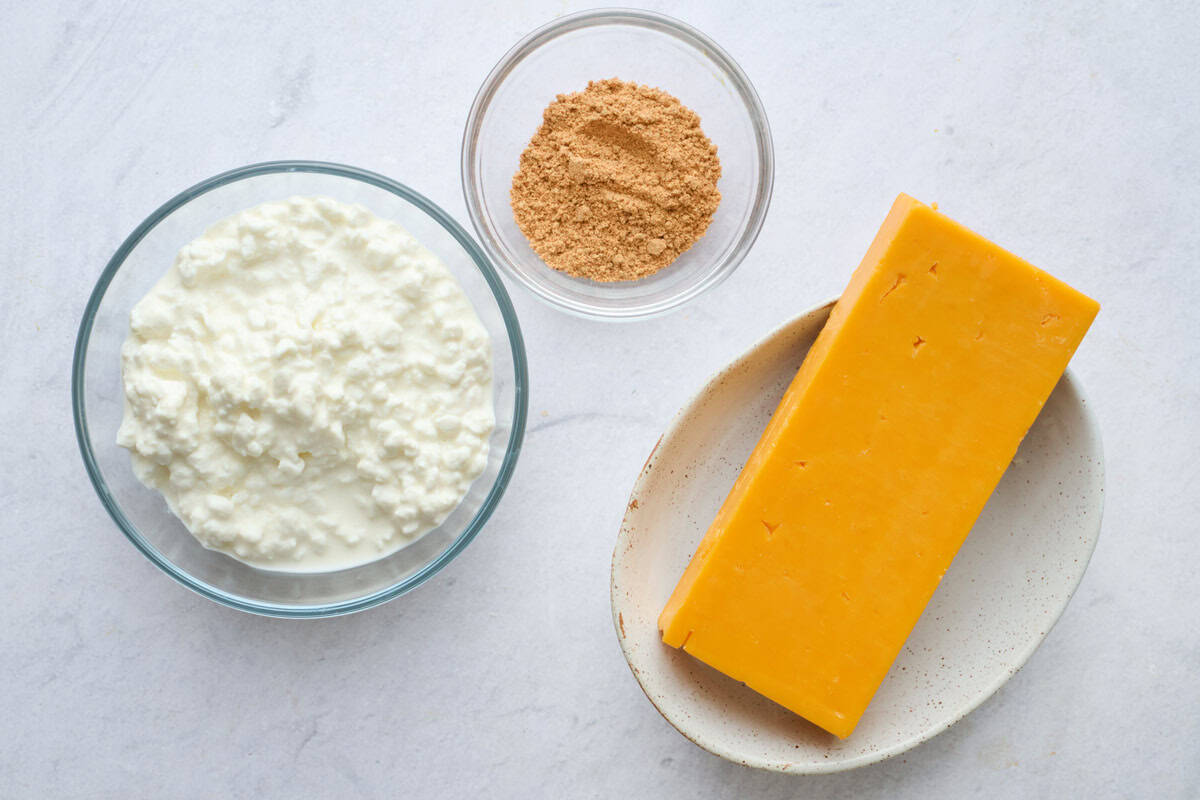Ingredients for queso recipe: cottage cheese, taco seasoning, block of cheddar cheese.