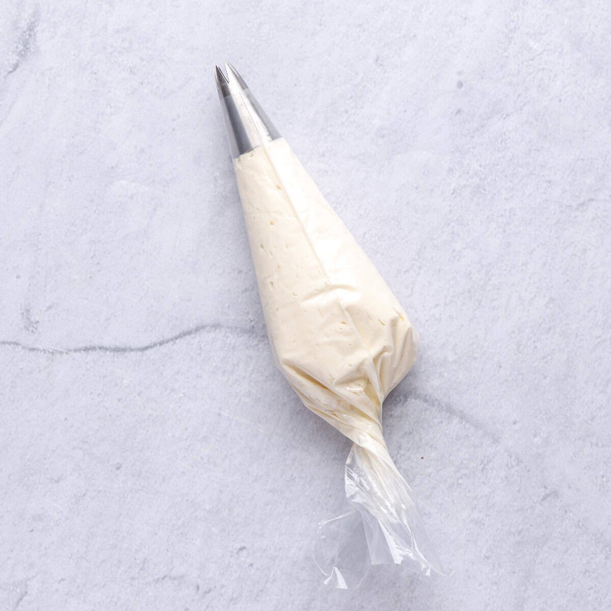 Cream cheese filling in a piping bag for filling strawberries.