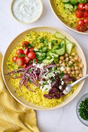 Best Mediterranean rice bowl recipe with toppings and a greek yogurt sauce.