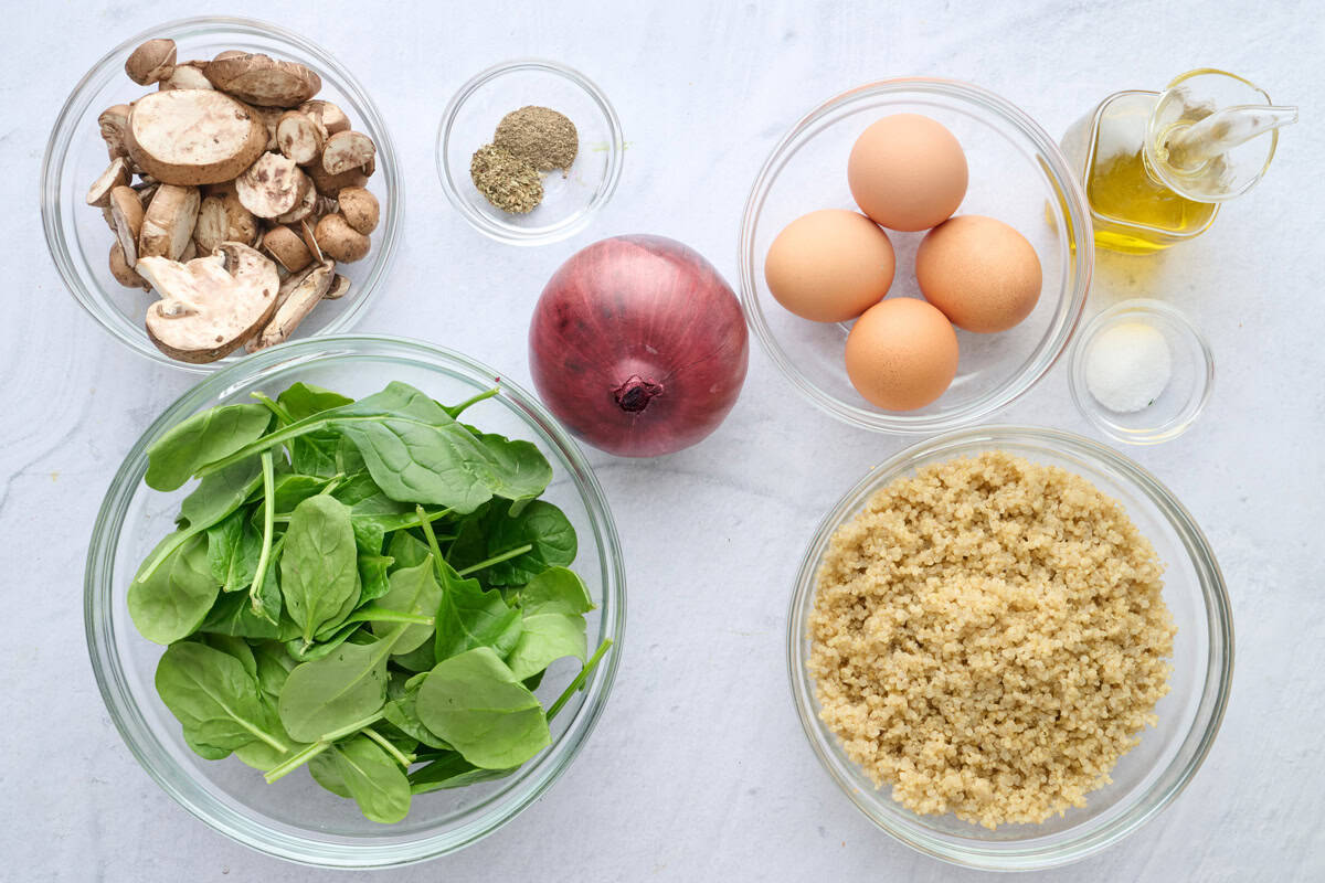 Ingredients for breakfast bowl recipe: mushrooms, spinach, quinoa, seasonings, onin, eggs, and oil.