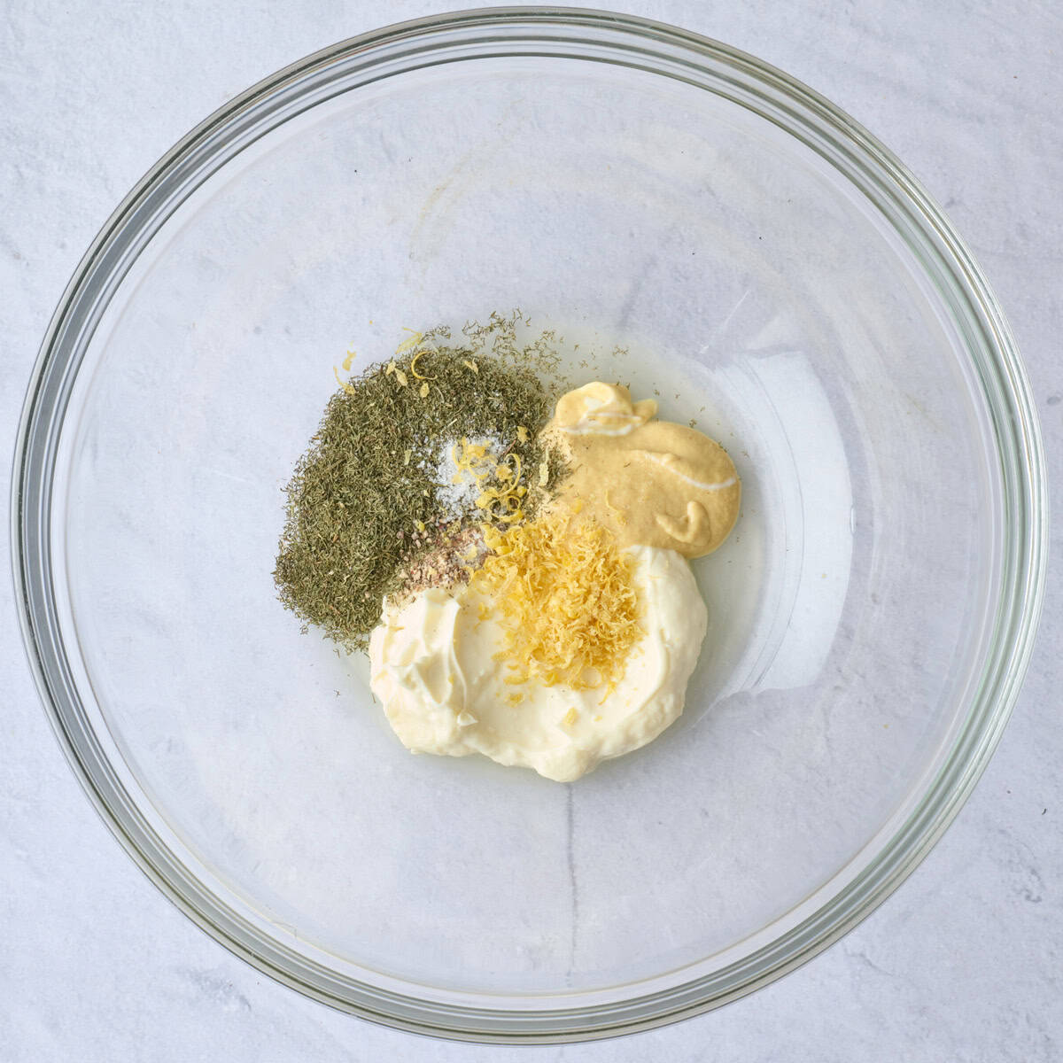 Mayo, lemon juice, mustard, dill, salt and pepper in a large bowl before mixing.