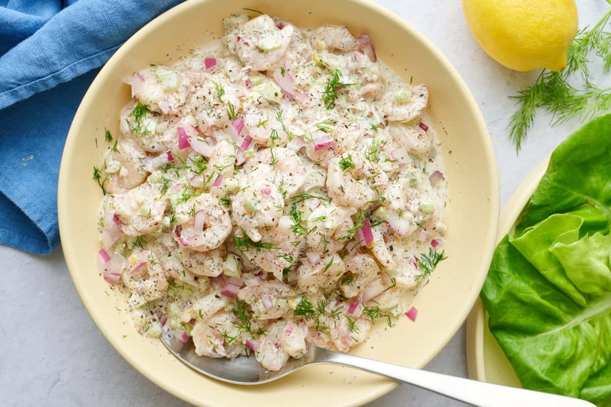 Cold shrimp salad recipe with dill and onions in a bowl.