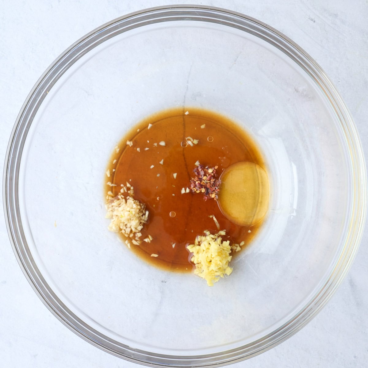 The dressing ingredients in a large bowl before whisking together.