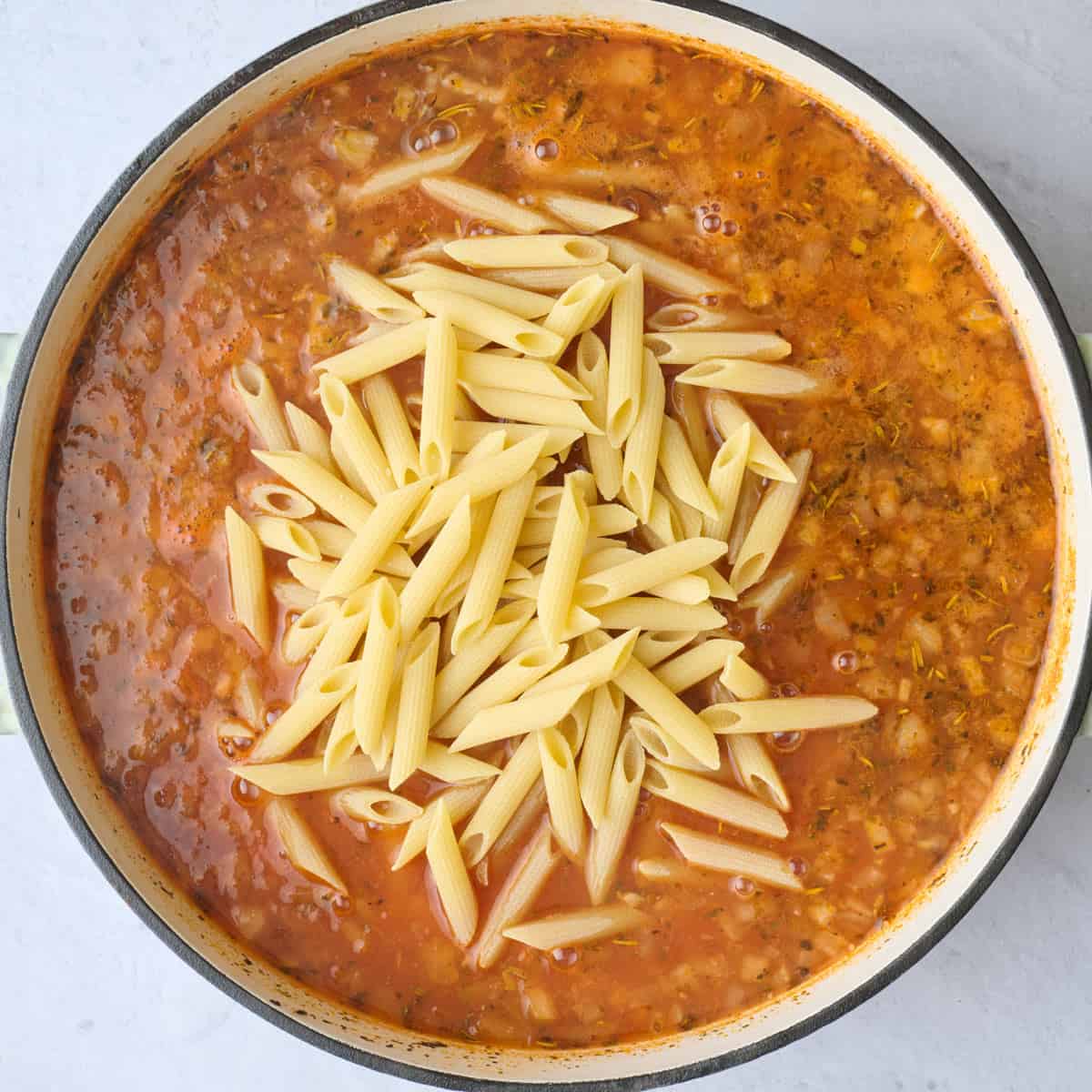 Combined and boiled sauce with pasta added to the pot.
